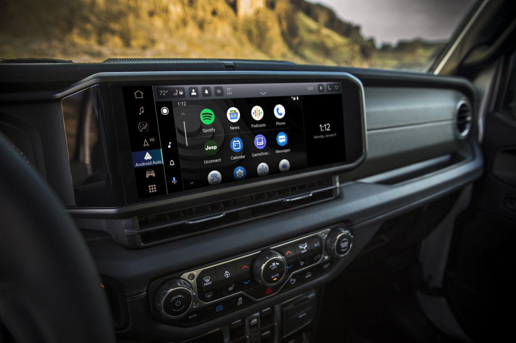Jeep Wrangler infotainment touchscreen running Android Auto with Spotify, News, Podcasts, and Uconnect apps